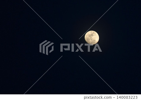 bright full moon floating on blue sky in twilight background bright full moon floating on blue sky in twilight background 140083223