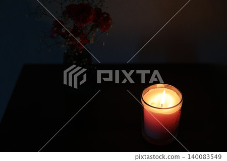 Carnations and candles in a dark room Carnations and candles in a dark room 140083549
