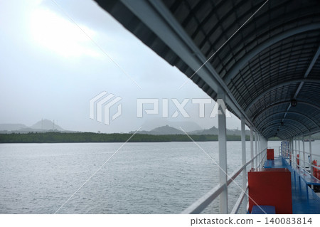 Covered Ferry Pier Walkway Overlooking Misty Mountains and Sea in Krabi 140083814