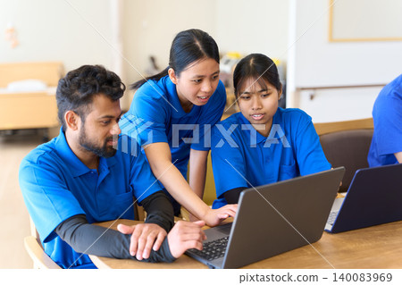 Southeast Asian caregivers undergoing training at a nursing home Southeast Asian caregivers undergoing training at a nursing home 140083969
