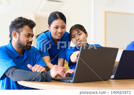 Southeast Asian caregivers undergoing training at a nursing home 140083972