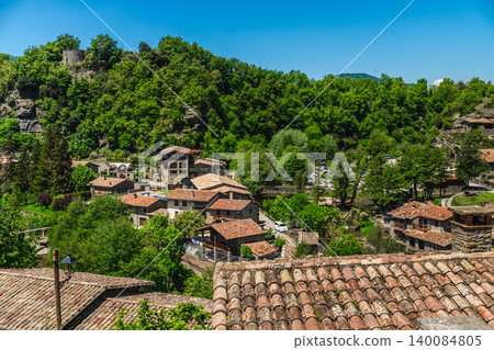 Panoramic view over rooftops of Rupit village surrounded by lush green forest in Catalonia, Spain Panoramic view over rooftops of Rupit village surrounded by lush green forest in Catalonia, Spain 140084805