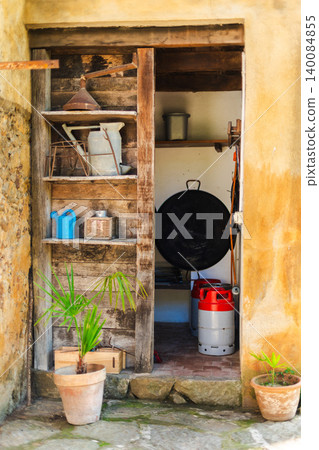 Rustic storage room with traditional household tools in Mediterranean country house Rustic storage room with traditional household tools in Mediterranean country house 140084855