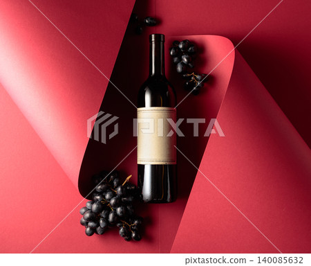 Bottle of red wine and blue grapes. 140085632