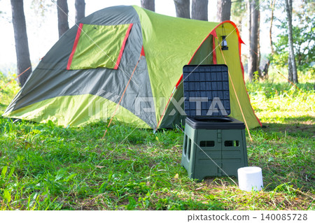 Camping tent with portable toilet and tissue roll, outdoor travel convenience, sanitary solution for wild nature areas, usage in tourism and camping. Camping tent with portable toilet and tissue roll, outdoor travel convenience, sanitary solution for wild nature areas, usage in tourism and camping. 140085728