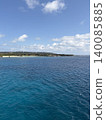 A beautiful emerald green sea and cape under a summer blue sky and white clouds. 140085885