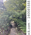 A beautiful scene of lush green stone steps bathed in the dappled sunlight of early summer and lush green maple leaves. 140085888