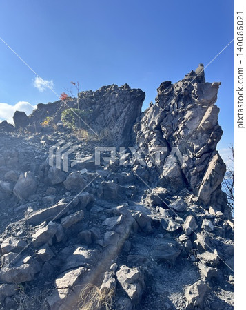 The dynamic lava and strangely shaped rocks of Sakurajima stand tall against the clear blue sky. The dynamic lava and strangely shaped rocks of Sakurajima stand tall against the clear blue sky. 140086021