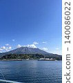 The calm blue sea and the magnificent panoramic view of Sakurajima from the ship. 140086022