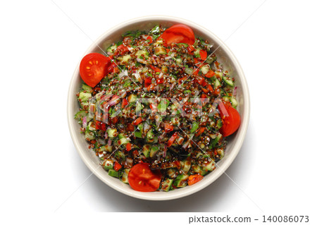 Healthy mixed salad in white bowl on wooden table. Mediterranean salad Healthy mixed salad in white bowl on wooden table. Mediterranean salad 140086073