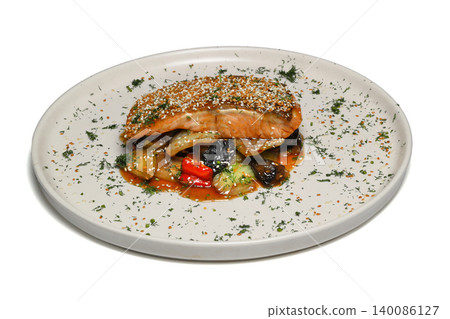 salmon steak with greens and sauce isolated on white background. 140086127