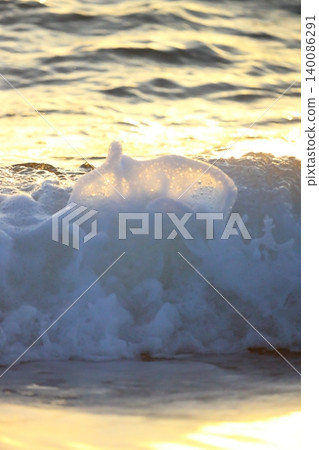 Wave splash at sunset close up. Ocean water in sunlight in motion. Abstract sea background Wave splash at sunset close up. Ocean water in sunlight in motion. Abstract sea background 140086291