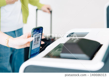 A person's hands as they self-check in their air ticket at the airport. (Photo courtesy of Kobe Airport (UKB)) A person's hands as they self-check in their air ticket at the airport. (Photo courtesy of Kobe Airport (UKB)) 140086313