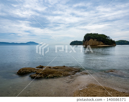 Misty panoramic landscape of Shodoshima Island with Seto Inland Sea, mountain ridges and drifting clouds. Misty panoramic landscape of Shodoshima Island with Seto Inland Sea, mountain ridges and drifting clouds. 140086371