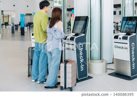 A couple using self-check-in at the airport. (Photo courtesy of Kobe Airport (UKB)) A couple using self-check-in at the airport. (Photo courtesy of Kobe Airport (UKB)) 140086395