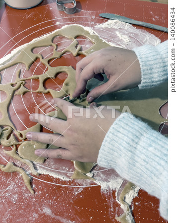Preparing tree shaped cookies from homemade dough Preparing tree shaped cookies from homemade dough 140086434