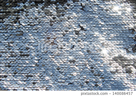 Silver sequin texture with shimmering scale pattern and reflective metallic sparkle surface Silver sequin texture with shimmering scale pattern and reflective metallic sparkle surface 140086457
