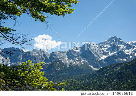 Travel landscape of Zugspitze mountain peak and forest in Alps in Bavaria, Germany, scenic summer nature panorama with forest Travel landscape of Zugspitze mountain peak and forest in Alps in Bavaria, Germany, scenic summer nature panorama with forest 140086618