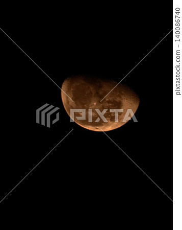 Blood Moon Orange Glow Against Black Night Sky 140086740