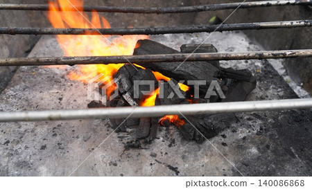 Glowing Charcoal and Fiery Flames on an Outdoor BBQ Grill Glowing Charcoal and Fiery Flames on an Outdoor BBQ Grill 140086868
