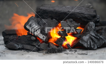 Vibrant Flames Dance on Glowing Charcoal for Grilling Vibrant Flames Dance on Glowing Charcoal for Grilling 140086878