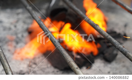 Close-up of Grill Grate Over Blazing Charcoal Fire Close-up of Grill Grate Over Blazing Charcoal Fire 140086882