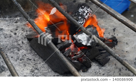 Vibrant Orange Flames on Hot Barbecue Charcoal Vibrant Orange Flames on Hot Barbecue Charcoal 140086900