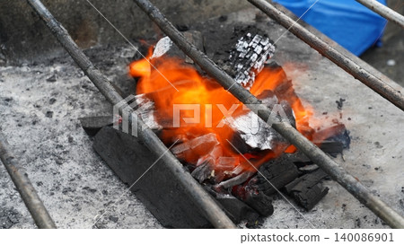 Fiery Charcoal Briquettes Under Metal Grill for BBQ Fiery Charcoal Briquettes Under Metal Grill for BBQ 140086901