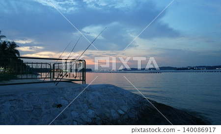 Serene Evening Fishing Scene by the Tropical Coast Serene Evening Fishing Scene by the Tropical Coast 140086917
