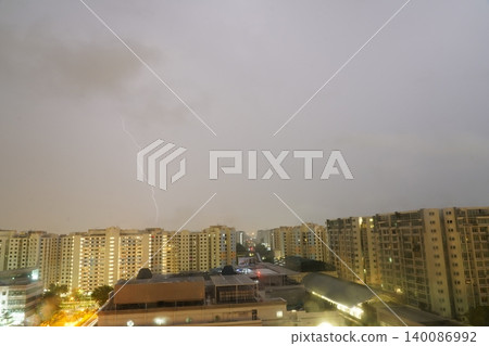 Lightning Strike Over City Buildings on a Cloudy Day Lightning Strike Over City Buildings on a Cloudy Day 140086992