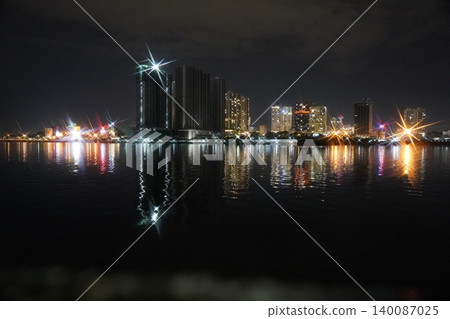 Cityscape at Night Reflected in Water Urban Night Scene Cityscape at Night Reflected in Water Urban Night Scene 140087025