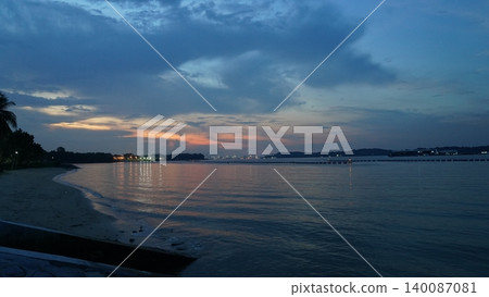 Peaceful Dusk Seascape with Reflective Ocean and Colorful Sky 140087081