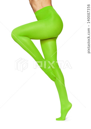 Woman's legs wearing neon lime green tights Woman's legs wearing neon lime green tights 140087356