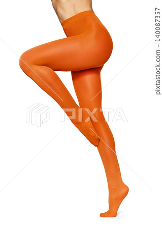 Woman's legs in vibrant orange opaque tights Woman's legs in vibrant orange opaque tights 140087357