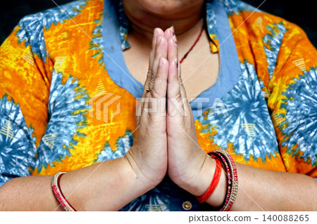 Woman Showing Namaste Gesture with Folded Hands in Traditional Indian Style 140088265