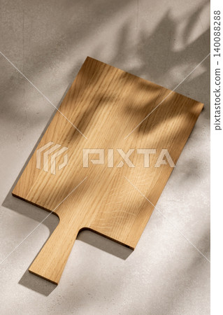 Rustic Wooden Cutting Board on Table with Sunny Shadows. Food Backdrop Rustic Wooden Cutting Board on Table with Sunny Shadows. Food Backdrop 140088288