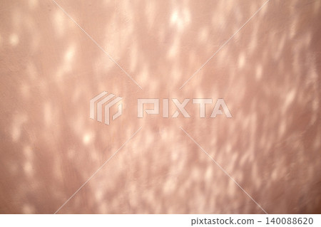 Soft pink wall with sunlight reflections and abstract textured light pattern 140088620