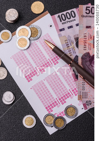 Lottery ticket, Mexican banknotes, and a pen, chance to win big, gambling. Lottery ticket Lottery ticket, Mexican banknotes, and a pen, chance to win big, gambling. Lottery ticket 140088730