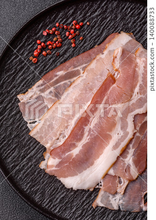 Raw fresh bacon slices with layers of meat or prosciutto with salt and spices. Raw bacon Raw fresh bacon slices with layers of meat or prosciutto with salt and spices. Raw bacon 140088733