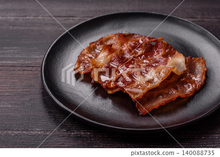 Fried fresh bacon slices with layers of meat or prosciutto with salt and spices. Fried bacon Fried fresh bacon slices with layers of meat or prosciutto with salt and spices. Fried bacon 140088735