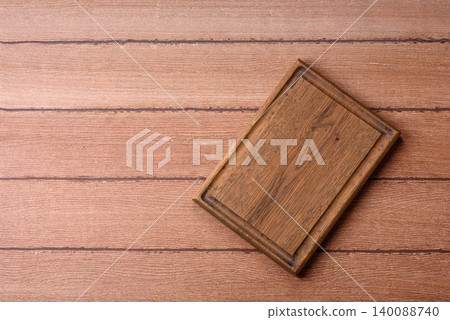 Empty wooden cutting board for preparing ingredients for home cooking. An empty cutting board 140088740