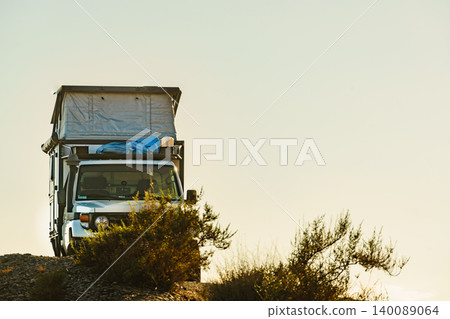 Off road vehicle with roof top tent camping on nature 140089064