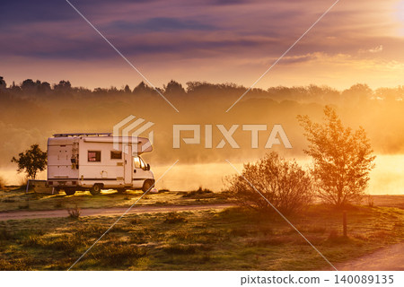 Rv caravan on lake shore. Autumn time, foggy morning Rv caravan on lake shore. Autumn time, foggy morning 140089135