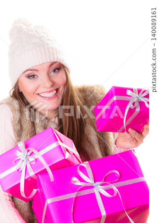 girl in warm winter clothes with many pink gift boxes girl in warm winter clothes with many pink gift boxes 140089161