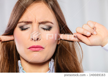Stressed woman with closed eyes put fingers in ears, Stressed woman with closed eyes put fingers in ears, 140089163