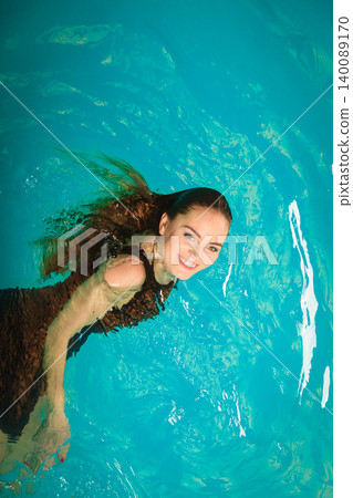 Woman floating relaxing in swimming pool water. Woman floating relaxing in swimming pool water. 140089170