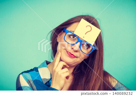 Thinking woman with big eyeglasses and light bulb Thinking woman with big eyeglasses and light bulb 140089232