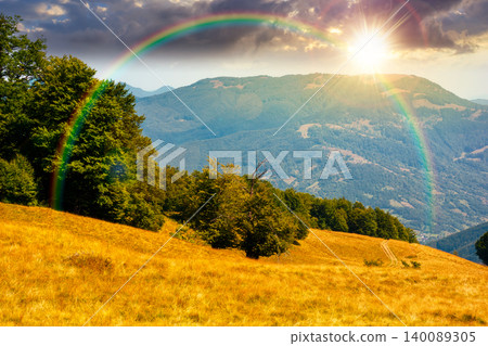 sunset over carpathian mountain landscape in summer. primeval beech forest on the grassy hill. wonderful scenery of ukrainian highlands. pristine ecosystem of europe. weather with rainbow sunset over carpathian mountain landscape in summer. primeval beech forest on the grassy hill. wonderful scenery of ukrainian highlands. pristine ecosystem of europe. weather with rainbow 140089305