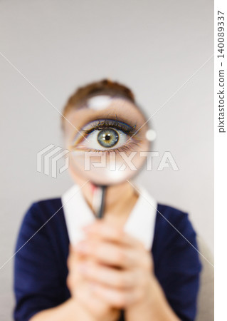 Funny woman office working secretary with magnifier Funny woman office working secretary with magnifier 140089337