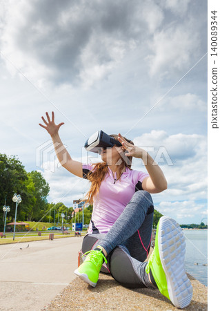 Woman wearing VR outside 140089344